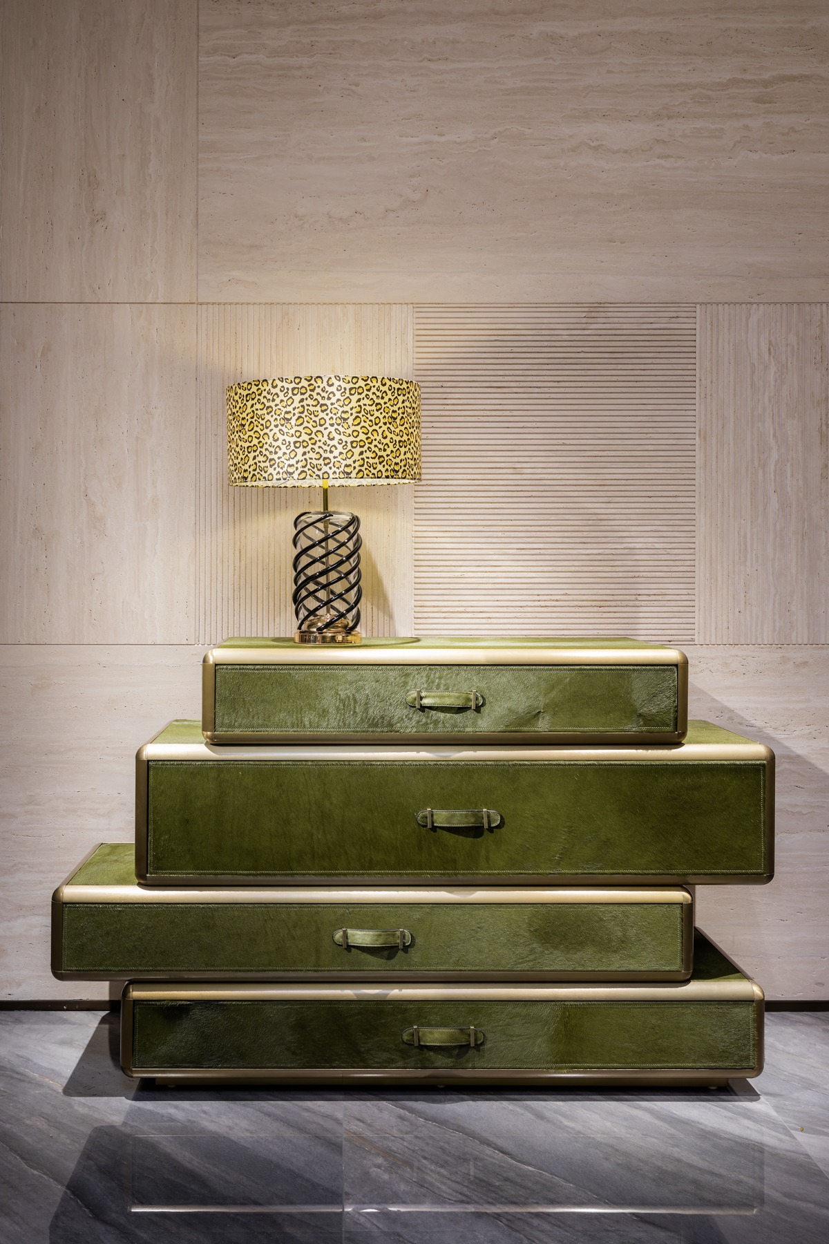 Stacked green storage drawers with lamp and metallic detailing