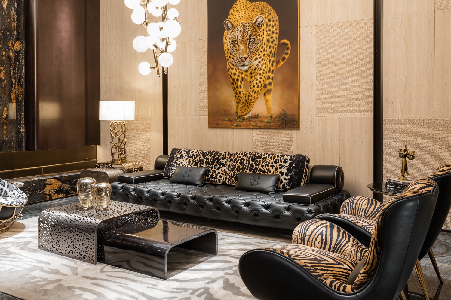 Black tufted sofa and patterned upholstered seating in a richly styled living room